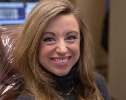 brunette woman in exam chair smiling with Invisalign