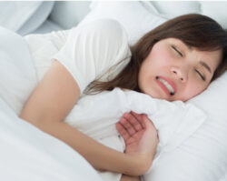 woman grinds her teeth while sleeping