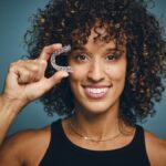 suresmile clear aligners, woman holding clear aligners
