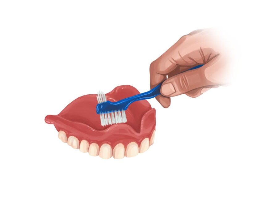 cleaning dentures with denture brush